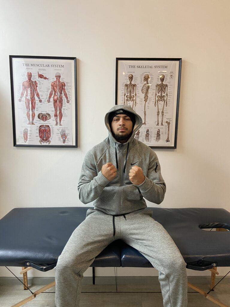 Male athlete working on strength and mobility during a physiotherapy session