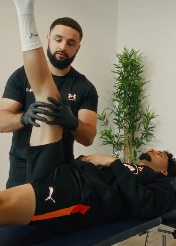 Professional athlete receiving treatment from a physiotherapy expert at our Manchester sports injury clinic.