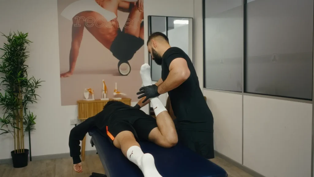 Professional athlete receiving treatment from a physiotherapy expert at our Manchester sports injury clinic.
